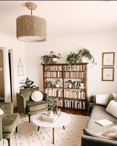 a living room filled with lots of furniture and bookshelves covered in plants on top of them