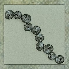 a drawing of several balls of yarn in the shape of a spiral on a gray background