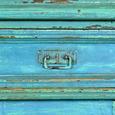 an old blue drawer with rusted metal handles