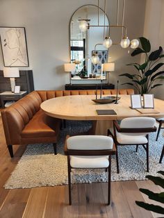 a living room with a couch, table and mirror in it's centerpiece