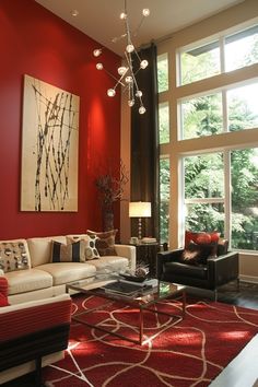 the living room is decorated in red and white with modern decor, including a chandelier