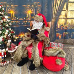 a santa clause sitting in a chair next to a christmas tree