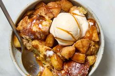 an apple cobbler with ice cream and caramel drizzle in a bowl