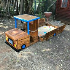 a wooden toy truck with a table on the back