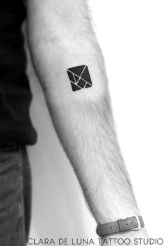 a black and white photo of a man's arm with an envelope tattoo on it