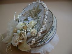 there are three hats that have flowers on top of each one and lace around the edges