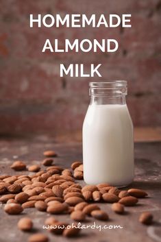 almond milk in a glass jar with almonds around it and the words homemade almond milk