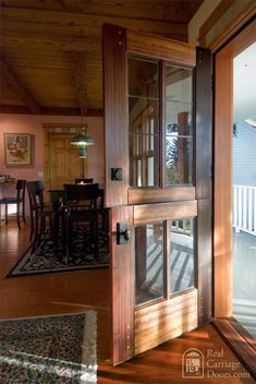 an open door leading to a deck and dining room