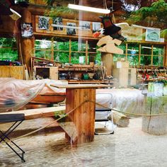 a room filled with lots of different types of furniture and decor on top of wooden tables