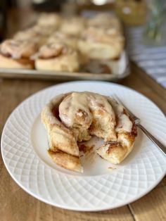 cinnamon rolls with icing on a white plate