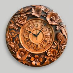 a wooden clock with flowers and leaves on it