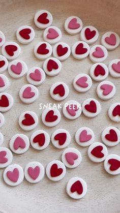 red and white hearts are arranged on a plate