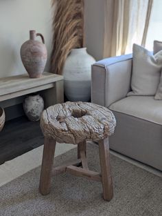 a living room filled with furniture and vases on top of it's tables