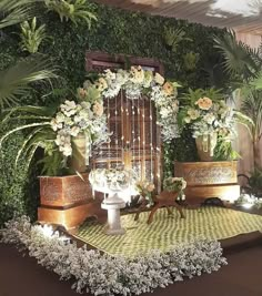 an arrangement of flowers and greenery on display