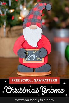 a christmas gnome sitting on top of a wooden table next to a tree with text overlay that reads free scroll saw pattern christmas gnome