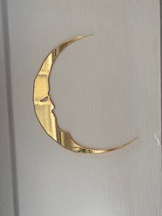 a gold crescent hanging on the side of a door