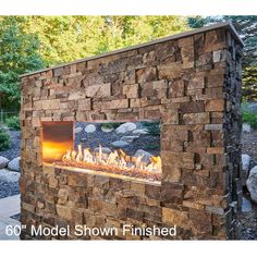 an outdoor fireplace with rocks surrounding it