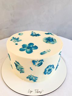 a white cake with blue flowers on it