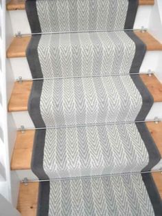 an image of a stair runner with wood treads and grey rug on the bottom