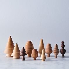 a group of wooden trees sitting on top of a white counter