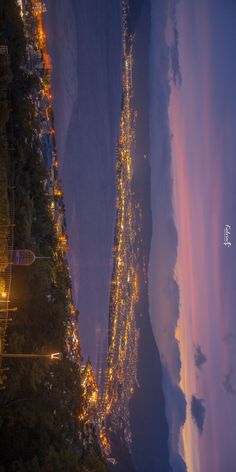 an aerial view of the city lights at night, taken from high up in the sky