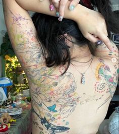 a woman with lots of tattoos on her back