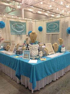 the table is set up with blue and white decorations on it, including mannequins