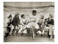 an old photo of baseball players sitting on a bench