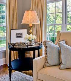 a living room filled with furniture and windows