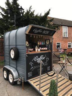 a small food cart with coffee on the side