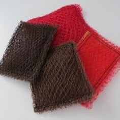 three pieces of red, brown and black fabric