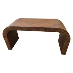 a wooden bench made out of wood with an unusual shape on the top and bottom