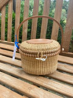 This 7-inch oval Nantucket-style covered basket purse was made with traditional methods using instructions from famous Nantucket basket maker, Martha Lawrence. The base, rims, and handle are cherry wood. Each basket is numbered, signed, and dated. The baskets can be personalized on the bottom, the number of characters based on the size of the base. These baskets make wonderful gifts, hostess gifts, house warming gifts, or gifts for your home. Nantucket Basket, Basket Purse, Nantucket Style, Nantucket Baskets, Character Base, Top Handle Bags, Cherry Wood, Nantucket, Hostess Gifts