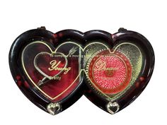 two heart shaped boxes with designs on them