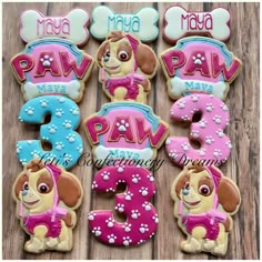 decorated cookies for a paw patrol birthday party with the number three and dog on them