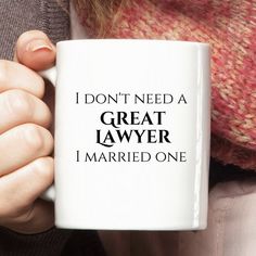 a woman holding a coffee mug with the words i don't need a great lawer, i married one