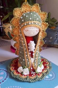 a crocheted doll is sitting on a table