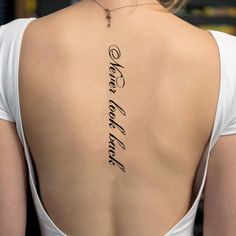 the back of a woman's neck with an inscription on it that says love