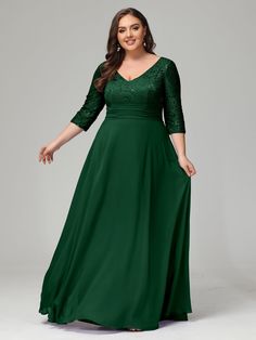 a woman in a long green dress with sleeves and lace detailing on the neckline