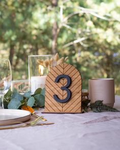 the table is set with candles and place settings