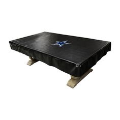 a black table with a new england football team logo on the top and two wooden legs