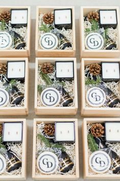 six wooden boxes filled with candles and pine cones