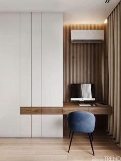 a room with a chair, desk and cabinets on the wall in front of it