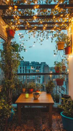 an outdoor patio with potted plants and lights on the ceiling, along with a wooden table