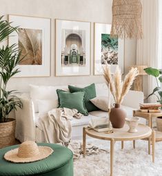 a living room filled with white furniture and lots of green pillows on top of it