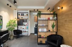 a hair salon with chairs and shelves full of products on the wall next to it