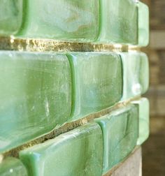 green glass tiles are stacked on top of each other