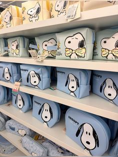 many bags with cartoon dogs on them in a store