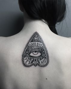 a woman's upper back tattoo with an all seeing eye and words on it