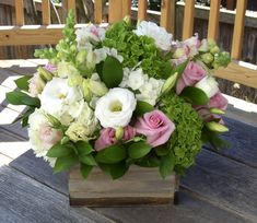 a bouquet of flowers sitting on top of a wooden table